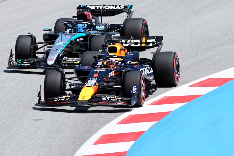 Red Bull's Max Verstappen overtakes Mercedes driver George Russell in Barcelona. The Briton would go on to finish in fourth place. AFP