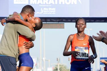 The women's Abu Dhabi Marathon winner Yashaneh is hugged as second placed finisher Chumba finishes behind. Leslie Pableo for The National
