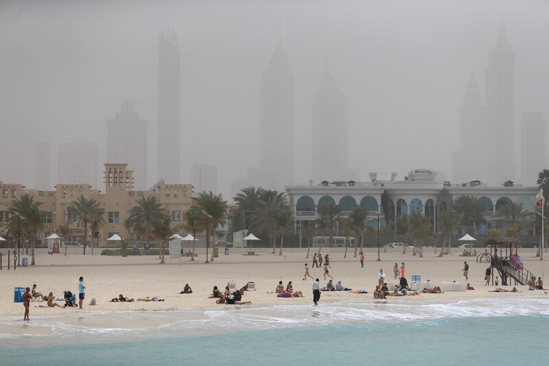 DUBAI, UAE. March 16, 2014- Beachgoers enjoy Jumeirah Open Beach amid a dusty skyline in Dubai, March 16, 2014. (Photo by: Sarah Dea/The National, Story by: STANDALONE, News)
