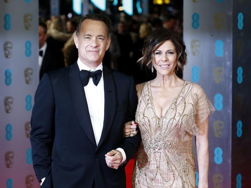 Tom Hanks, left, and his wife Rita Wilson arrive on the red carpet. Andrew Cowie / AFP photo