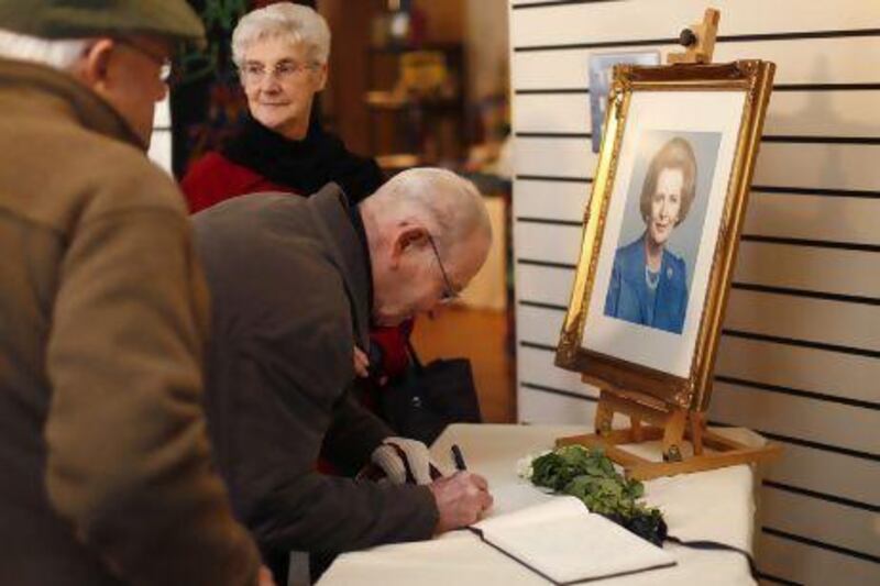 Visitors sign a condolence book for the former British prime minister Margaret Thatcher in Grantham, central England.