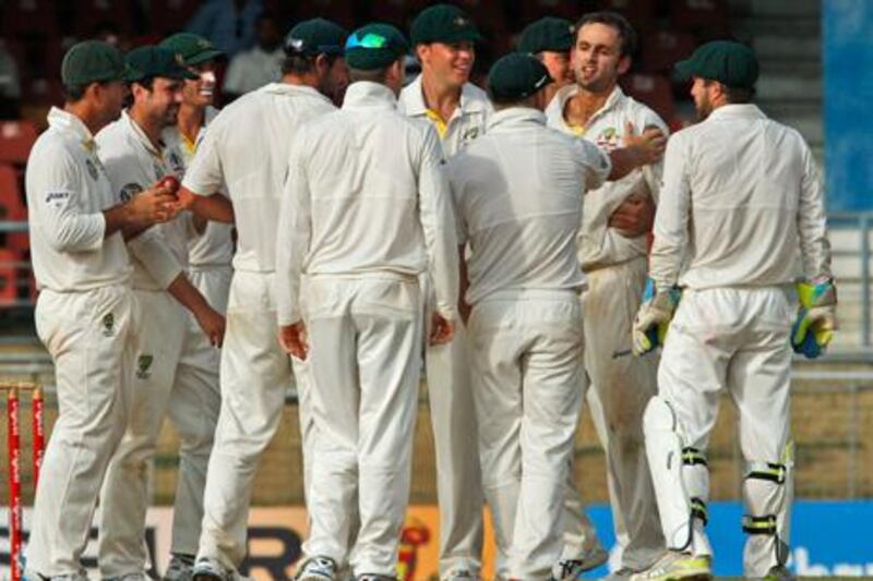 Australia's bowler Nathan Lyon, second from right, celebrates with teammates after the umpire ruled the LBW of West Indies' batsman Shivnarine Chanderpau to dismiss him for 94 runs during the third day of their second cricket Test match in Port of Spain, Trinidad, Tuesday, April 17, 2012. (AP Photo/Arnulfo Franco)