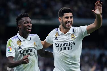 Real Madrid's Marco Asensio, right, celebrates with Vinicius Junior after scoring the opening goal during the Spanish La Liga soccer match between Real Madrid and Celta Vigo at the Santiago Bernabeu stadium in Madrid, Spain, Saturday, April 22, 2023.  (AP Photo / Manu Fernandez)