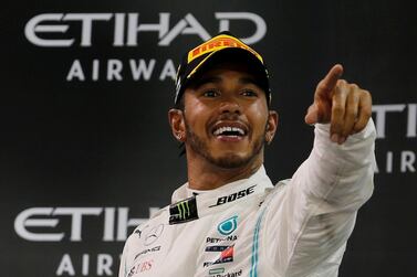 FILE PHOTO: Formula One F1 - Abu Dhabi Grand Prix - Yas Marina Circuit, Abu Dhabi, United Arab Emirates - December 1, 2019 Mercedes' Lewis Hamilton celebrates with a trophy after winning the race REUTERS/Hamad I Mohammed/File Photo