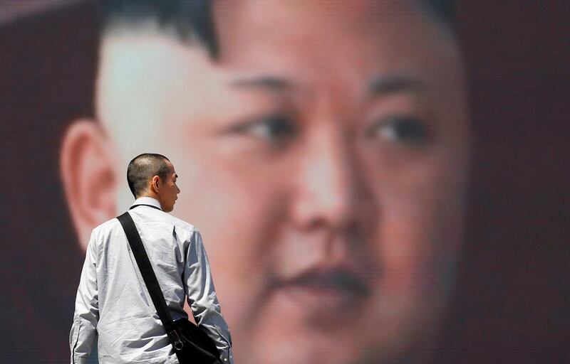 A man walks past a street monitor showing North Korea's leader Kim Jong Un in a news report about North Korea's announcement, in Tokyo, Japan, April 21, 2018. REUTERS/Toru Hanai