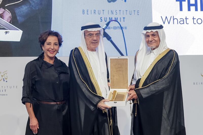 Zaki Nusseibeh, Minister of State, receives an award of recognition from the Beirut Institute, presented by Raghida Dergham, founder of Beirut Institute, left, and Saudi Arabia’s Prince Turki Al Faisal ​​​​. Beirut Institute