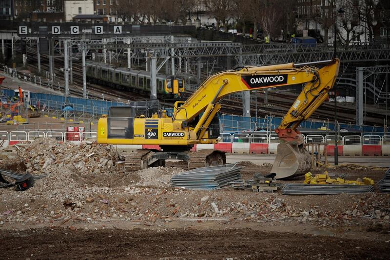 A train passes the construction site of the High Speed 2 (HS2) rail line at Euston station in London, Tuesday, Feb. 11, 2020.  Britain's Conservative government is set to approve a contentious, expensive plan for a high-speed rail line linking London with central and northern England, despite opposition from environmentalists and even some members of the governing party. (AP Photo/Matt Dunham)