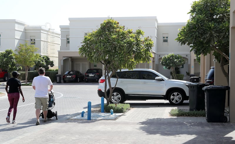 ABU DHABI ,  UNITED ARAB EMIRATES , AUGUST 28 – 2019 :- Jon Edwards ( in white t-shirt ) at the Al Ghadeer residential area in Abu Dhabi. These residents are worried about the dangerous driving by the car drivers around the area. ( Pawan Singh / The National ) For News. Story by Patrick
