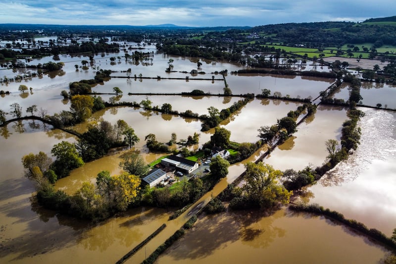 Flooded fields in Powys, Wales, after Storm Babet battered the UK, causing widespread flooding and high winds. PA