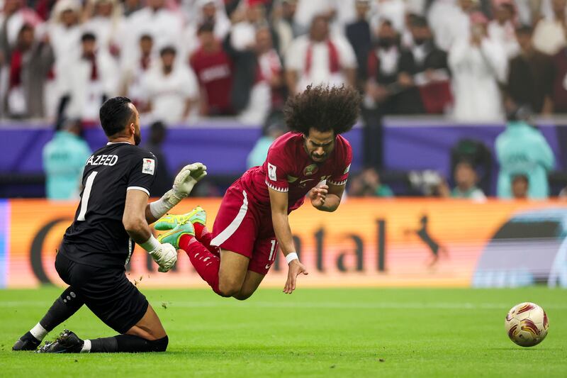 Akram Afif of Qatar is fouled by Jordan keeper Yazeed Abulaila to concede a penalty that led to the third goal for the striker. Getty Images