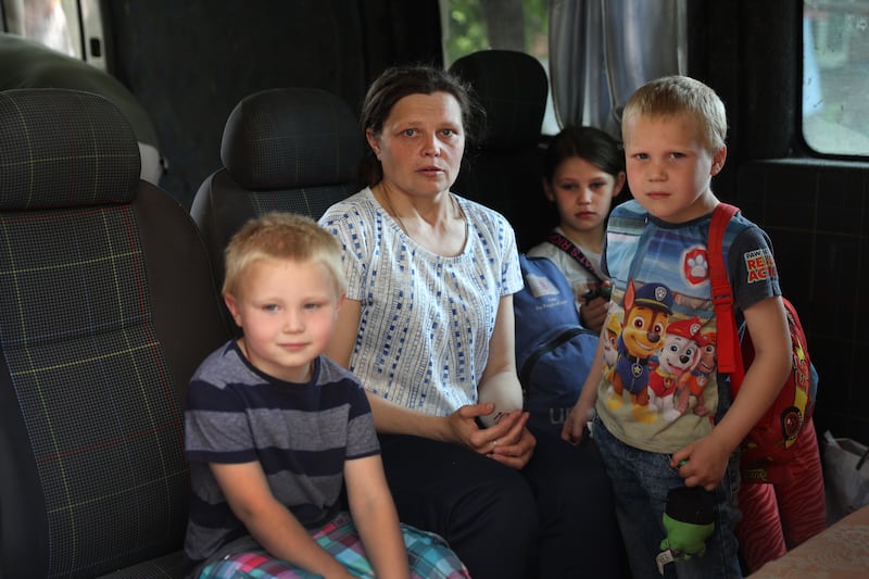 Maryna Golovnia sits in a van with her children as they leave their home in Bakhmut, amid fighting. Getty Images