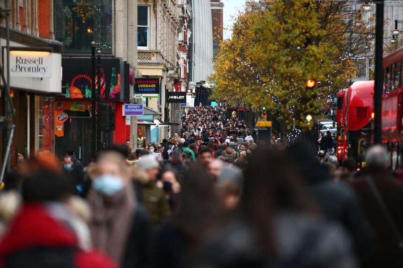 Shoppers, some wearing face masks, walk along a busy Oxford Street in London, England, on December 5, 2020. London has returned to so-called Tier 2 or 'high alert' coronavirus restrictions since the end of the four-week, England-wide lockdown last Wednesday, meaning a reopening of non-essential shops and hospitality businesses as the festive season gets underway. Rules under all three of England's tiers have been strengthened from before the November lockdown, however, with pubs and restaurants most severely impacted. In London's West End, meanwhile, Oxford Street and Regent Street were both packed with Christmas shoppers this afternoon, with the retail sector hoping for a strong end to one of its most difficult years. (Photo by David Cliff/NurPhoto via Getty Images)