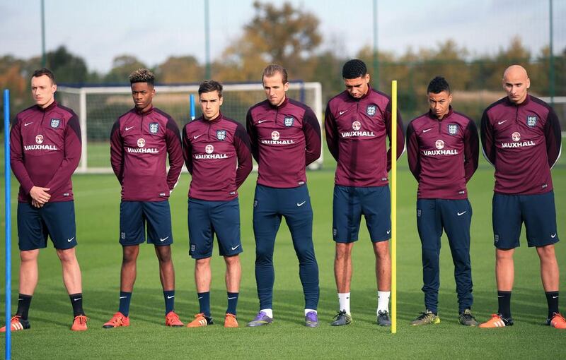 England national football team players observe a period of silence on November 16, 2015, for the Paris victims during a training session at Enfield Training Centre in London. England will play France at Wembley Stadium on Tuesday. John Walton / PA via Associated Press