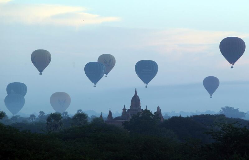 Hot air balloons fly over the Myanmar's old temple just before sunrise in Bagan, Nyaung U district, central Myanmar. AP Photo