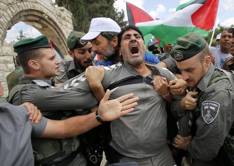 A Palestinian protestor is detained by Israeli Border Police during a demonstration in the occupied West Bank. Abed Al Hashlamoun / EPA