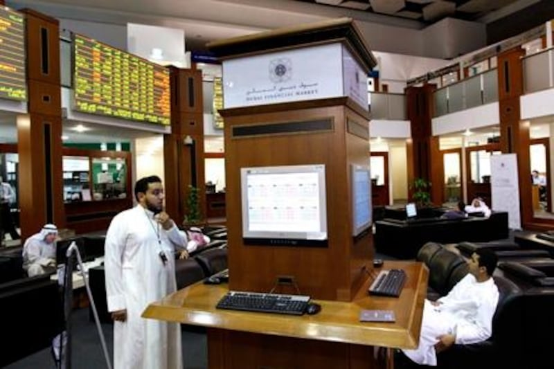 Investors view monitors at the Dubai International Financial Market, May 20, 2010. Dubai World [DBWLD.UL], the state-owned conglomerate, has reached a deal in principal to restructure $23.5 billion with its core lenders, clearing one hurdle for Dubai but leaving investors with other debt concerns. REUTERS/Ahmed Jadallah (UNITED ARAB EMIRATES - Tags: BUSINESS) *** Local Caption ***  DUB05_DUBAIWORLD-_0520_11.JPG