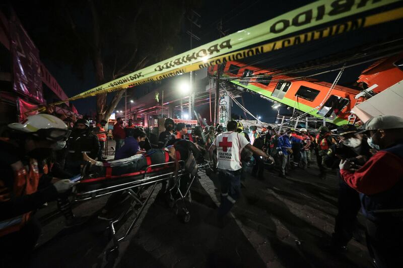 Injured people are carried away by stretcher after a raised subway track collapsed in Mexico City. Getty