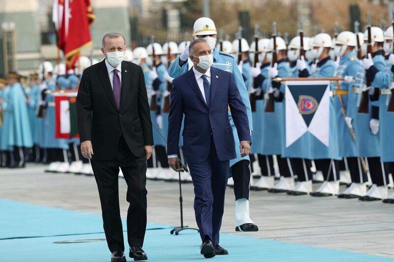 Turkish President Recep Tayyip Erdogan and Iraqi Prime Minister Mustafa Al Kadhimi review a guard of honour at the presidential palace in Ankara. AP