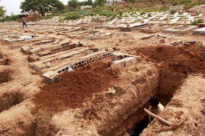 FILE PHOTO: A man digs a grave at a cemetery where victims of the coronavirus disease (COVID-19) are buried in Taiz, Yemen June 23, 2020. Picture taken June 23, 2020. REUTERS/Anees Mahyoub/File Photo