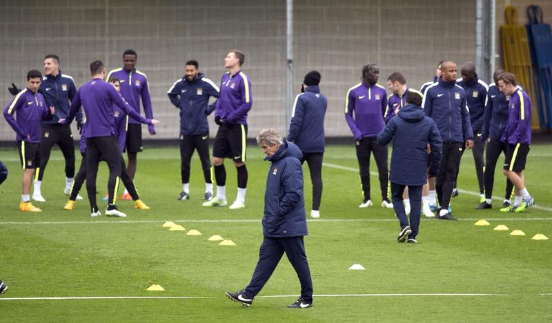 Manuel Pellegrini, centre, attends a Manchester City’s training session. Oli Scarff / AFP