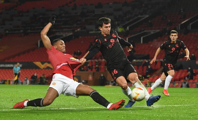 Real Sociedad's Spanish midfielder Martin Zubimendi (R) beats Manchester United's French striker Anthony Martial (L) to a cross during the UEFA Europa League Round of 32, 2nd leg football match between Manchester United and Real Sociedad at Old Trafford in Manchester, north west England, on February 25, 2021. / AFP / Oli SCARFF
