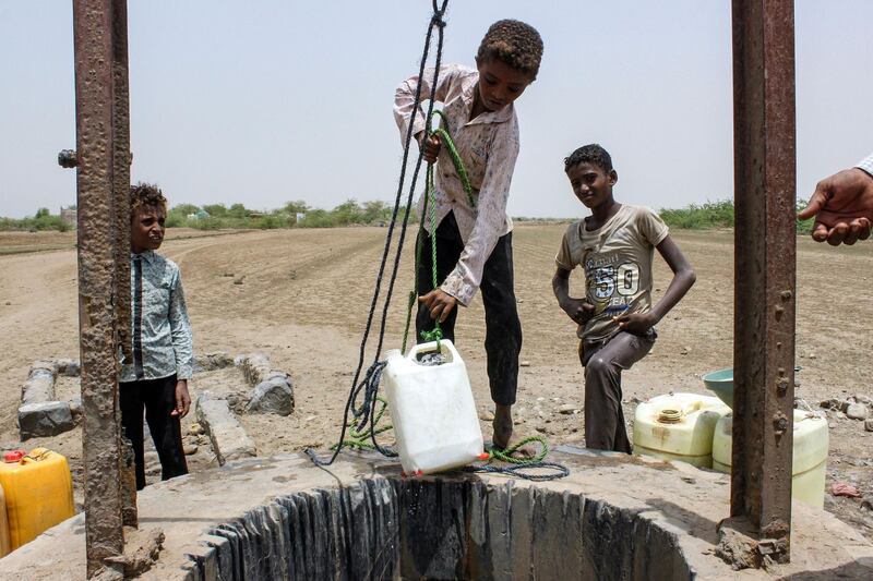 Boys displaced from the eastern Yemeni district of Durahemi draw water from a well inear the Red Sea port city of Hodeida.  AFP