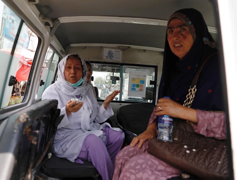 Afghan women sit in an ambulance after being rescued by security forces during an attack and gunfire at a hospital in Kabul, Afghanistan. REUTERS
