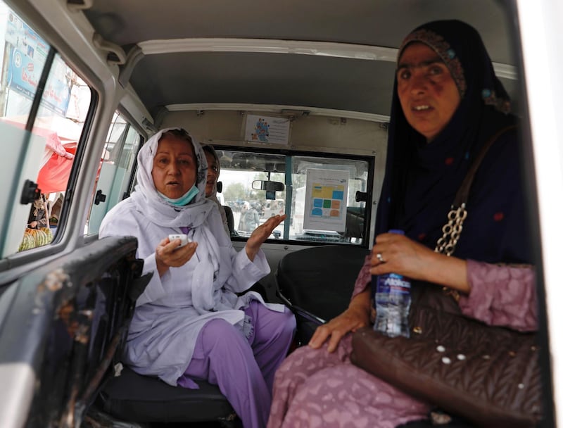Afghan women sit in an ambulance after being rescued by security forces during an attack and gunfire at a hospital in Kabul, Afghanistan. REUTERS