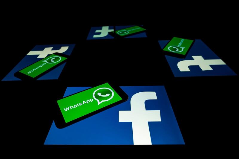 (FILES) This file photo taken on October 5, 2020 shows the logo of US social network Facebook and mobile messaging service WhatsApp on the screens of a smartphone and a tablet in Toulouse, southwestern France. Secure messaging app Signal is at the top downloads on Apple Store and Google Play platforms in several countries after the popular messaging app WhatsApp asked its some two billion users on January 7, 2021 to accept new terms that will allow it to share more information with its parent company Facebook and roll out advertising and e-commerce.  / AFP / Lionel BONAVENTURE
