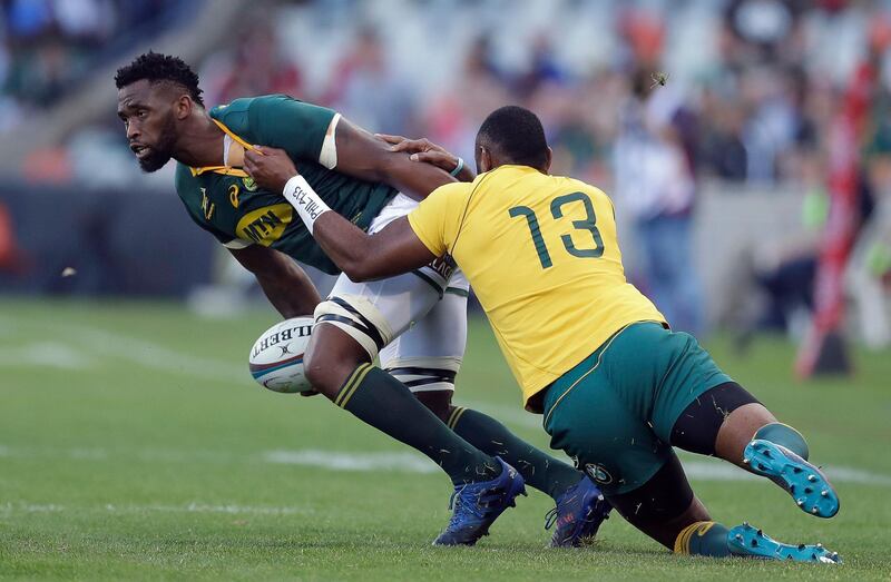 FILE - In this Sept. 30, 2017 file photo South Africa's Siya Kolisi, left, is tackled by Australia's Tevita Kuridrani, during a Rugby Championship match between South Africa and Australia, at the Free State Stadium in Bloemfontein, South Africa. Kolisi has become the first black player to be appointed captain of South Africaâ€™s test rugby team, it was reported on Monday, May 28, 2018. Kolisi has been named captain for the series against England next month. (AP Photo/Themba Hadebe, File)