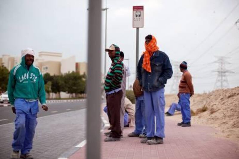 A group of labourers wait for their bus on the northern end of the Discovery Gardens in Dubai on January 22, 2012. Christopher Pike / The National

For story by: None
