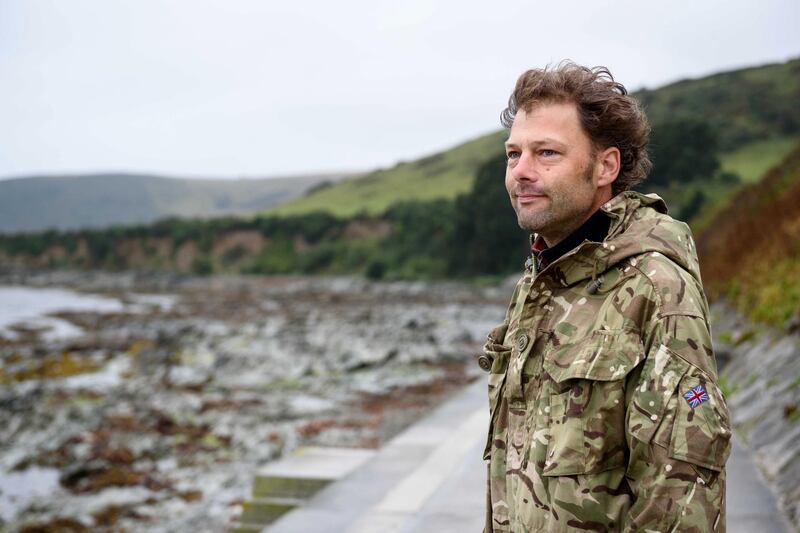 LOOE, CORNWALL, ENGLAND, August 16, 2019. Patrick "Paddy" Saunders surveys a bee forage on a hillside on a rugged stretch of coastline. Polly Stock for The National