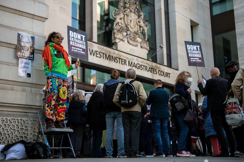 Supporters of Assange protest outside court. The extradition order must be signed by Ms Patel, after which Assange can try to challenge the decision by judicial review. Getty Images