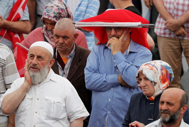 Supporters of the ruling AK Party (AKP) wait for the arrival of their mayoral candidate Binali Yildirim during an election rally in Istanbul, Turkey, June 21, 2019. REUTERS/Murad Sezer