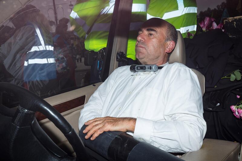 An Extinction Rebellion protester sits with a bike lock around his neck inside a funeral hearse during a rally in Trafalgar Square in London, Britain, October 7, 2019. EPA/VICKIE FLORES