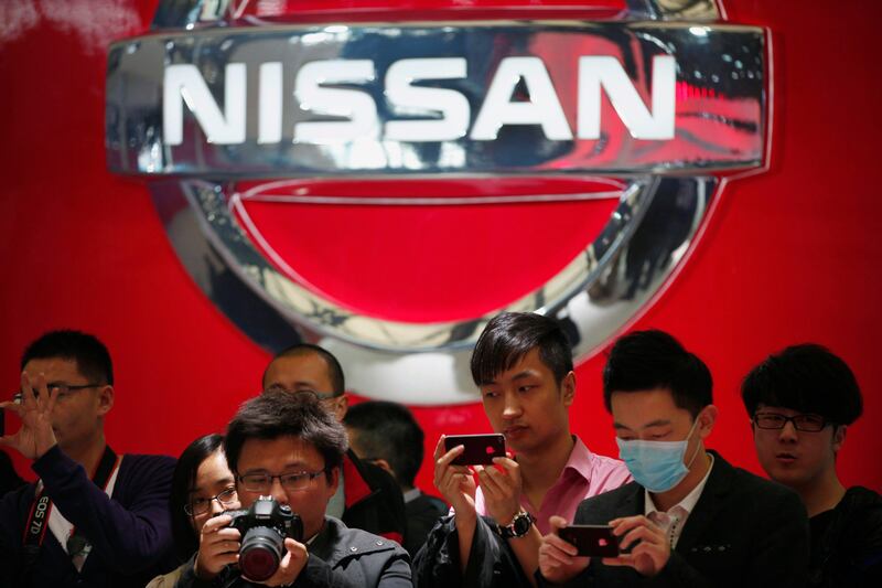 People take pictures of Nissan cars during the 15th Shanghai International Automobile Industry Exhibition in Shanghai April 21, 2013. China's premier auto show opened in Shanghai on Saturday, with global and local automakers showcasing new models, technologies and strategies. China is the world's biggest autos market and - while growth has slowed from its blistering pace of recent years - is a key battleground for an industry that has stuttered in the U.S. and Europe.  REUTERS/Carlos Barria  (CHINA - Tags: BUSINESS TRANSPORT) *** Local Caption ***  CB17_AUTOSHOW-CHINA_0421_11.JPG