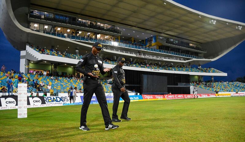 BRIDGETOWN, BARBADOS - SEPTEMBER 23: In this handout image provided by CPL T20, Umpires Gregory Brathwaite (L) and Nigel Duguid (R) walk onto the field before the start of match 20 of the Hero Caribbean Premier League between Barbados Tridents and Jamaica Tallawahs at Kensington Oval on September 23, 2019 in Bridgetown, Barbados. (Photo by Randy Brooks - CPL T20/CPL T20 via Getty Images)
