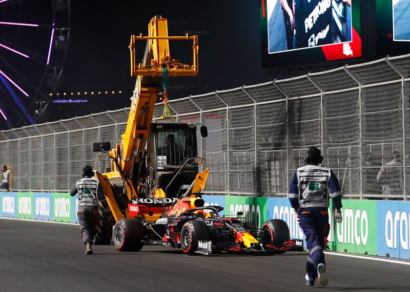 Stewards remove the car of Red Bull's Max Verstappen following his crash during qualifying. Reuters