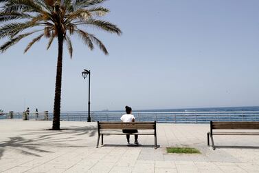 A woman sits on a bench along the seaside corniche of the Lebanese capital Beirut, as a lockdown imposed by the authorities during the coronavirus pandemic begins to ease.  AFP  