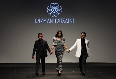 Naomi Campbell with designers Ruzaini Jamil, left, and Rizman Nordin at the Rizman Ruzaini show during Dubai Fashion Week. EPA