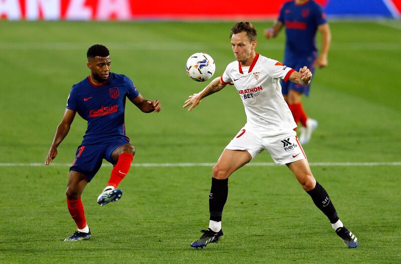 Atletico Madrid's Thomas Lemar in action with Sevilla's Ivan Rakitic. Reuters