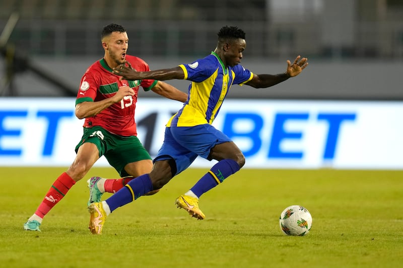 Tanzania's Morice Abraham tries to break clear with the ball against Morocco's Selim Amallah. AP