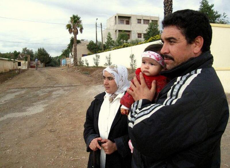 Abdalla el Bechnaoui and his wife Jamila Aarrach with their daughter, Tiziri, in Zerarda. John Thorne / The National