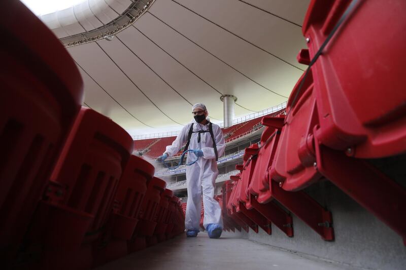 Workers spray disinfectant in the seating area prior to the match between Chivas de Guadalajara and Pachuca in the Guardians 2020 tournament at the Akron Stadium in Guadalajara, Jalisco, Mexico. EPA