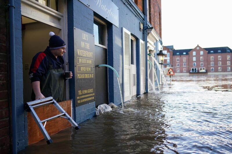 A man looks out over the flood defences at a cafe by the River Ouse in York. Getty Images