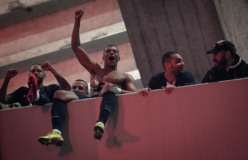 Neymar, Kylian Mbappe, Layvin Kurzawa and Eric Maxim Choupo Moting celebrate on the top tier of the stadium in front of supporters outside. AFP