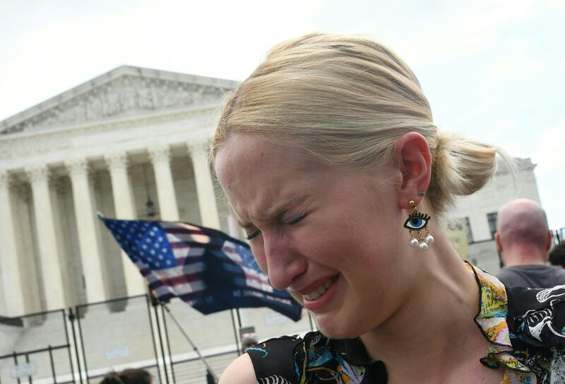 A pro-choice supporter cries outside the Supreme Court. AFP