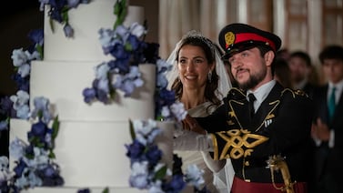 Jordan's Crown Prince Hussein and Princess Rajwa cut the cake during their wedding in Amman. AP
