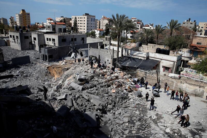 Palestinians inspect a destroyed Hamas site after it was targeted by an Israeli air strike. Reuters