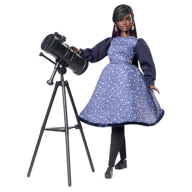 Dr Maggie Aderin-Pocock MBE doll features a rendition of the space scientist wearing a starry dress and has a telescope accessory - a nod to Dr Aderin-Pocock's work with the James Webb Space Telescope. 
 
